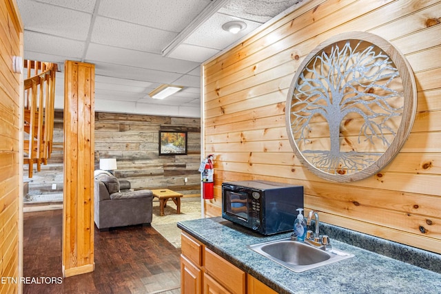 1815 Silver Poplar Ln, Sevierville, TN 37876 - bar featuring wood walls, black microwave, a sink, and dark wood-style flooring