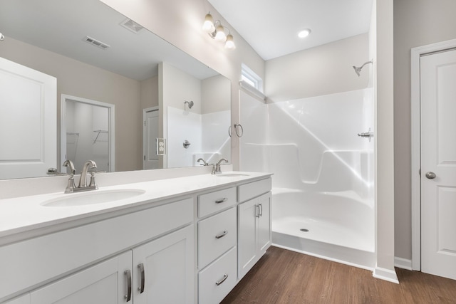 34 Aurora Cir, Fayetteville, TN 37334 - bathroom with double vanity, wood finished floors, a shower, and a spacious closet