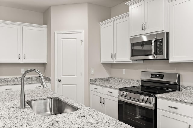 34 Aurora Cir, Fayetteville, TN 37334 - kitchen featuring appliances with stainless steel finishes, a sink, white cabinets, and light stone counters
