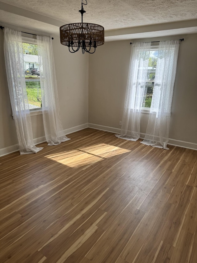 1210 Daniel St, Clarksville, TN 37040 - unfurnished dining area featuring baseboards, a chandelier, and wood finished floors