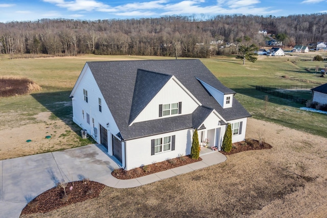 163 Autumn Wind Dr SW, Cleveland, TN 37311 - view of front of property with a garage, a shingled roof, driveway, a front yard, and a view of trees