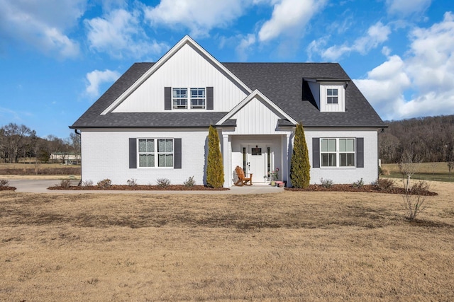 163 Autumn Wind Dr SW, Cleveland, TN 37311 - modern inspired farmhouse featuring brick siding, roof with shingles, and a front lawn