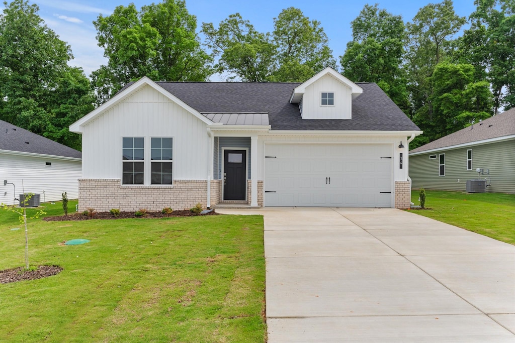 30 Aurora Cir, Fayetteville, TN 37334 - view of front of property with board and batten siding, central AC unit, an attached garage, and brick siding