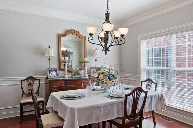 4118 Pretoria Run, Murfreesboro, TN 37128 - dining room with a chandelier, crown molding, a wainscoted wall, dark wood-style flooring, and a decorative wall