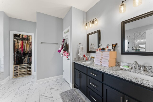 4115 Andes Dr, Murfreesboro, TN 37127 - bathroom with double vanity, marble finish floors, baseboards, and a walk in closet