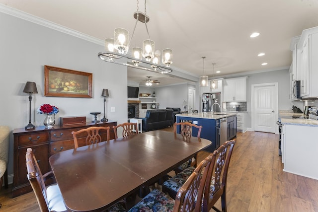 4115 Andes Dr, Murfreesboro, TN 37127 - dining space featuring ceiling fan, a chandelier, crown molding, a fireplace, and recessed lighting