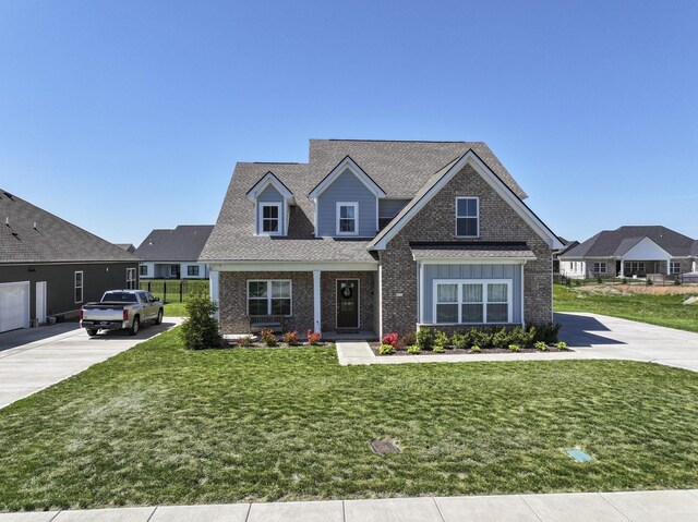 4115 Andes Dr, Murfreesboro, TN 37127 - view of front of property with brick siding, a front yard, roof with shingles, and driveway
