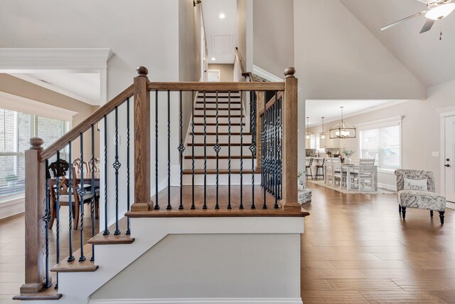 1114 Escalade Ct, Lascassas, TN 37085 - staircase featuring wood finished floors, a ceiling fan, high vaulted ceiling, a chandelier, and recessed lighting