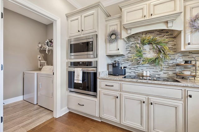 1114 Escalade Ct, Lascassas, TN 37085 - kitchen featuring stainless steel appliances, independent washer and dryer, backsplash, and light wood-type flooring