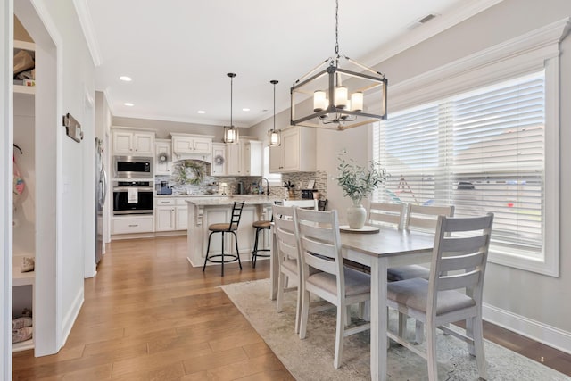 1114 Escalade Ct, Lascassas, TN 37085 - dining area featuring ornamental molding, a chandelier, light wood-style floors, baseboards, and recessed lighting
