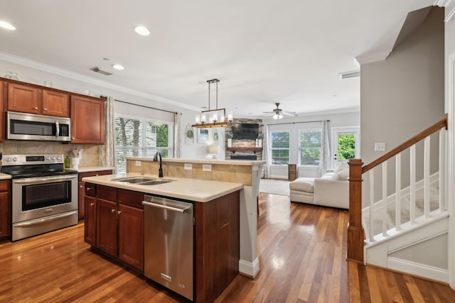 3324 Redmon Hl, Nolensville, TN 37135 - kitchen featuring appliances with stainless steel finishes, a sink, healthy amount of natural light, crown molding, and light countertops