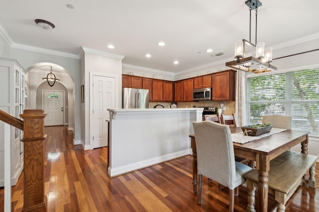3324 Redmon Hl, Nolensville, TN 37135 - dining space with arched walkways, a chandelier, ornamental molding, dark wood finished floors, and recessed lighting