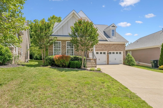 3324 Redmon Hl, Nolensville, TN 37135 - view of front of home with driveway, brick siding, a front yard, a garage, and board and batten siding