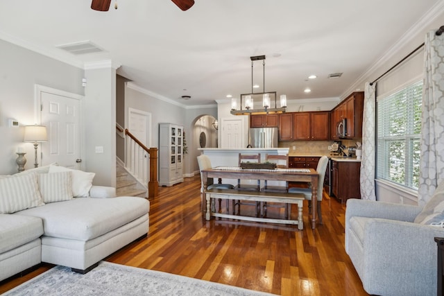 3324 Redmon Hl, Nolensville, TN 37135 - living area featuring arched walkways, wood finished floors, stairs, ceiling fan, and crown molding