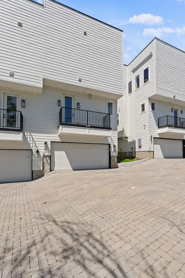 1203B Brick Church Pike, Nashville, TN 37207 - back of property with an attached garage, a balcony, and decorative driveway