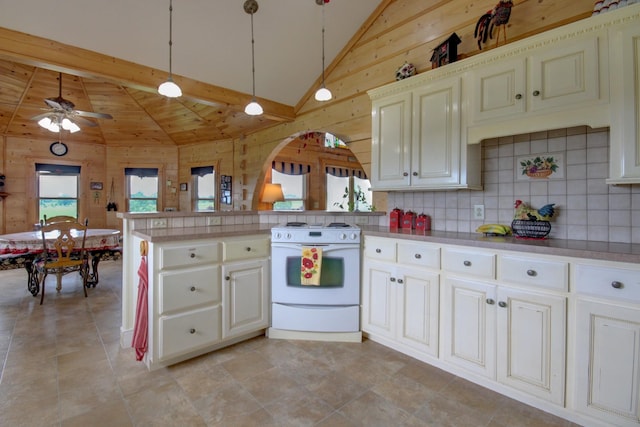 1820 Buck Smith Rd, Palmyra, TN 37142 - kitchen featuring white stove, a peninsula, wooden walls, ceiling fan, and high vaulted ceiling