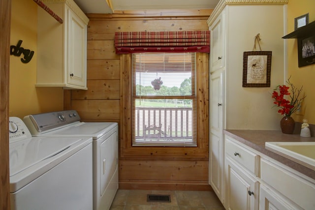 1820 Buck Smith Rd, Palmyra, TN 37142 - laundry area with cabinet space, washer and clothes dryer, and wood walls