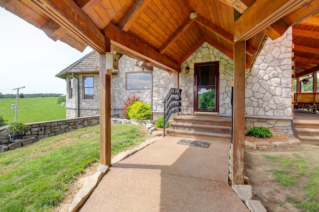 1820 Buck Smith Rd, Palmyra, TN 37142 - doorway to property featuring stone siding, a yard, and covered porch