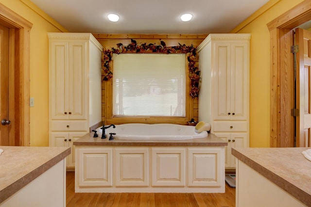 1820 Buck Smith Rd, Palmyra, TN 37142 - bathroom featuring vanity, a garden tub, wood finished floors, and recessed lighting