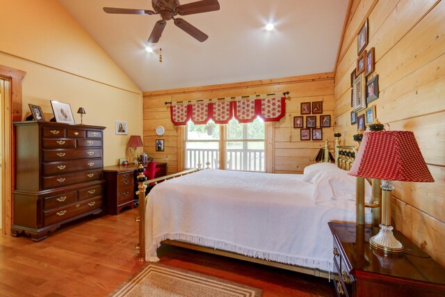 1820 Buck Smith Rd, Palmyra, TN 37142 - bedroom featuring wooden walls, wood finished floors, a ceiling fan, access to outside, and high vaulted ceiling