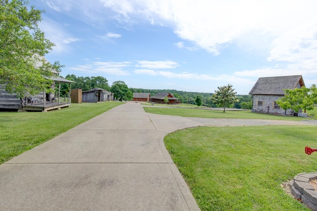 1820 Buck Smith Rd, Palmyra, TN 37142 - view of grassy yard featuring a wooden deck, driveway, and an outdoor structure