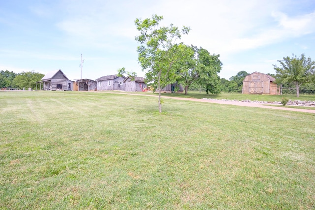 1820 Buck Smith Rd, Palmyra, TN 37142 - view of green lawn with a barn and an outdoor structure