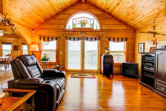 1820 Buck Smith Rd, Palmyra, TN 37142 - living area with plenty of natural light, wood walls, hardwood / wood-style flooring, wooden ceiling, and a wood stove