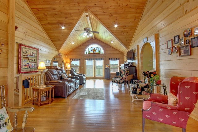 1820 Buck Smith Rd, Palmyra, TN 37142 - living area with wooden walls, wood finished floors, a ceiling fan, high vaulted ceiling, and arched walkways