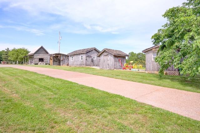 1820 Buck Smith Rd, Palmyra, TN 37142 - view of front of house with an outbuilding and a front yard