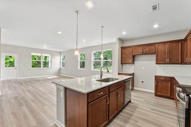 36 Aurora Cir, Fayetteville, TN 37334 - kitchen with a sink, stainless steel appliances, light wood-style floors, light stone countertops, and decorative backsplash