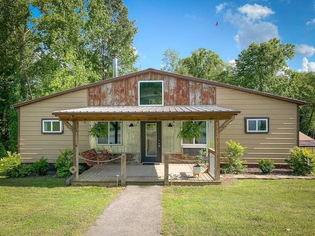 6969 Cuba Landing Rd, Waverly, TN 37185 - view of front of property with a front lawn, metal roof, and a deck