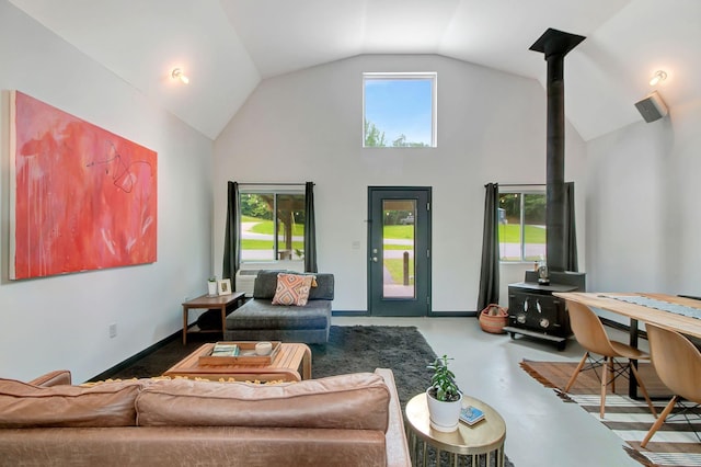 6969 Cuba Landing Rd, Waverly, TN 37185 - living room featuring a wood stove, high vaulted ceiling, and finished concrete flooring
