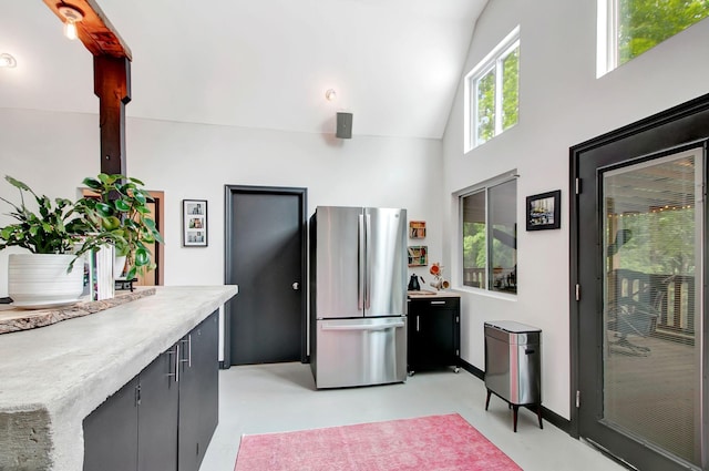 6969 Cuba Landing Rd, Waverly, TN 37185 - kitchen featuring freestanding refrigerator, concrete flooring, light countertops, high vaulted ceiling, and baseboards