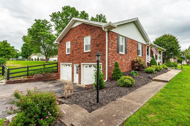 120 Brookhaven Dr, Gallatin, TN 37066 - view of home's exterior featuring asphalt driveway, brick siding, and a garage