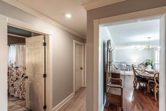 120 Brookhaven Dr, Gallatin, TN 37066 - hall featuring ornamental molding, wood finished floors, a chandelier, and baseboards