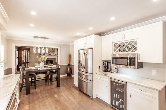 120 Brookhaven Dr, Gallatin, TN 37066 - kitchen with appliances with stainless steel finishes, wine cooler, crown molding, white cabinets, and recessed lighting