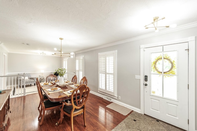 120 Brookhaven Dr, Gallatin, TN 37066 - dining room with a chandelier, ornamental molding, a textured ceiling, baseboards, and dark wood-style floors