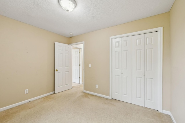 2956 Augusta Trace Dr, Spring Hill, TN 37174 - unfurnished bedroom featuring carpet, baseboards, a textured ceiling, and a closet
