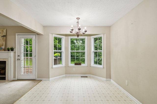 2956 Augusta Trace Dr, Spring Hill, TN 37174 - unfurnished dining area with a chandelier, a fireplace, baseboards, and a textured ceiling