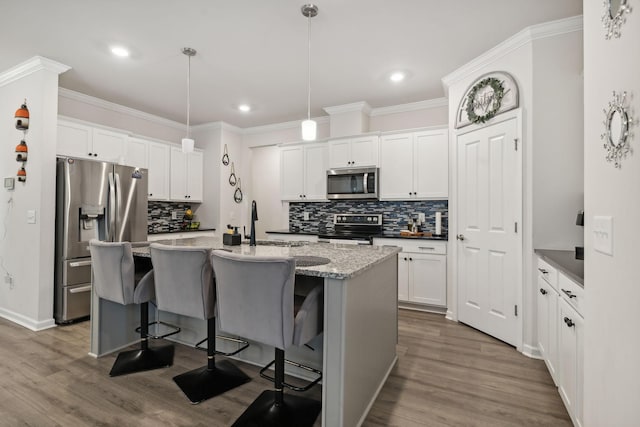 4537 Rockland Trl, Antioch, TN 37013 - kitchen featuring stainless steel appliances, backsplash, recessed lighting, dark wood finished floors, and a center island with sink