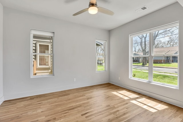 2514B Booker St, Nashville, TN 37208 - empty room with plenty of natural light, light wood-style flooring, a ceiling fan, and baseboards