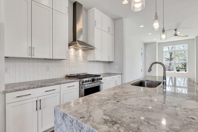 2514B Booker St, Nashville, TN 37208 - kitchen featuring wall chimney range hood, high end range, a sink, light stone counters, and backsplash
