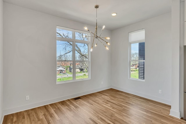 2514B Booker St, Nashville, TN 37208 - unfurnished room with a chandelier, light wood finished floors, and baseboards