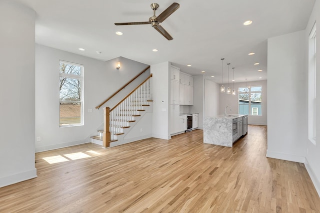 2514B Booker St, Nashville, TN 37208 - unfurnished living room with a sink, recessed lighting, a ceiling fan, light wood-type flooring, and stairway