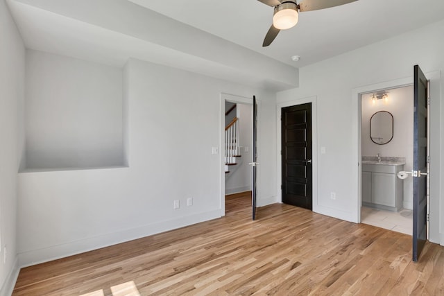 2514B Booker St, Nashville, TN 37208 - unfurnished bedroom with light wood-style flooring, baseboards, connected bathroom, and a sink