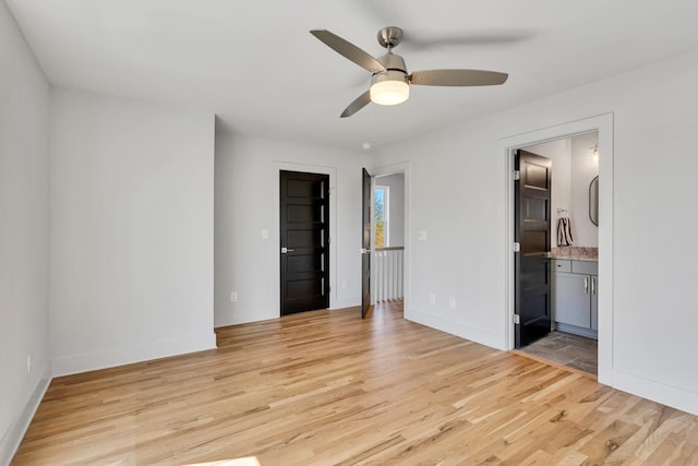2514B Booker St, Nashville, TN 37208 - unfurnished bedroom with light wood-style floors, baseboards, and connected bathroom