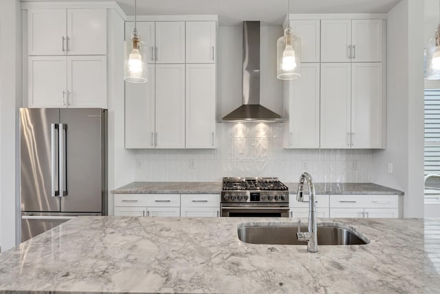 2514B Booker St, Nashville, TN 37208 - kitchen with appliances with stainless steel finishes, wall chimney range hood, a sink, light stone counters, and decorative backsplash