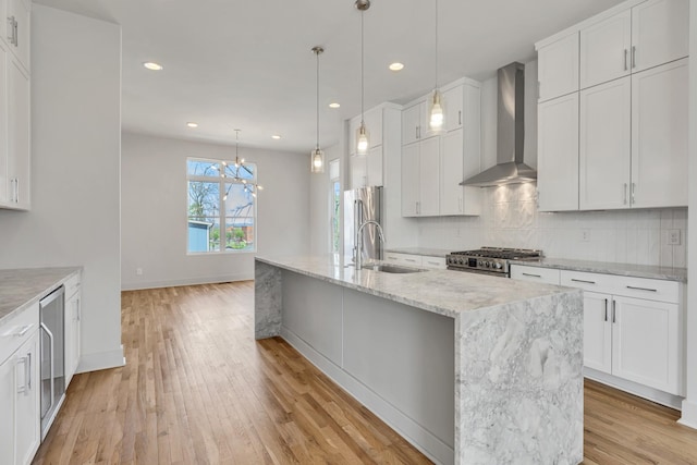 2514B Booker St, Nashville, TN 37208 - kitchen with wall chimney exhaust hood, a sink, appliances with stainless steel finishes, light wood-style floors, and recessed lighting