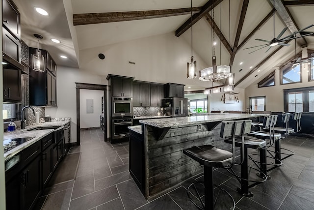 464 Old, Petersburg Park, Petersburg, TN 37144 - kitchen featuring appliances with stainless steel finishes, light stone counters, tasteful backsplash, beamed ceiling, and a large island