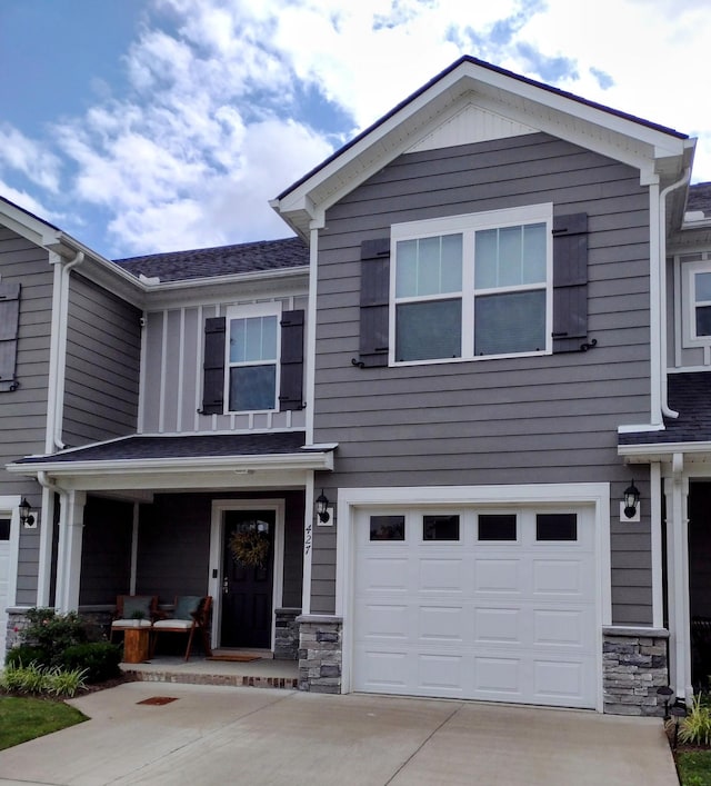 427 Tristan Way, Spring Hill, TN 37174 - view of front facade with concrete driveway, a garage, stone siding, and a porch